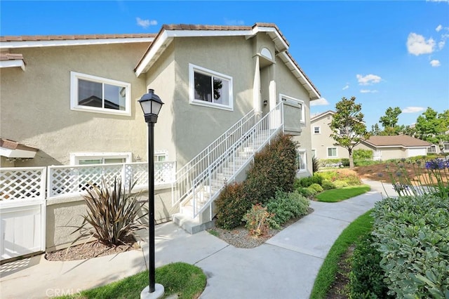 549 Springbrook N, Irvine, CA 92614 - view of home's exterior with stairway and stucco siding