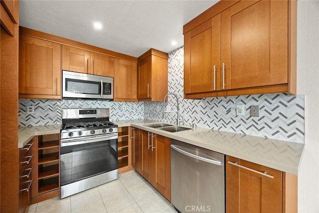 549 Springbrook N, Irvine, CA 92614 - kitchen with appliances with stainless steel finishes, brown cabinetry, a sink, tasteful backsplash, and recessed lighting