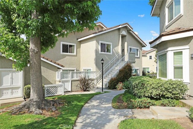 549 Springbrook N, Irvine, CA 92614 - view of front facade with stucco siding and stairs