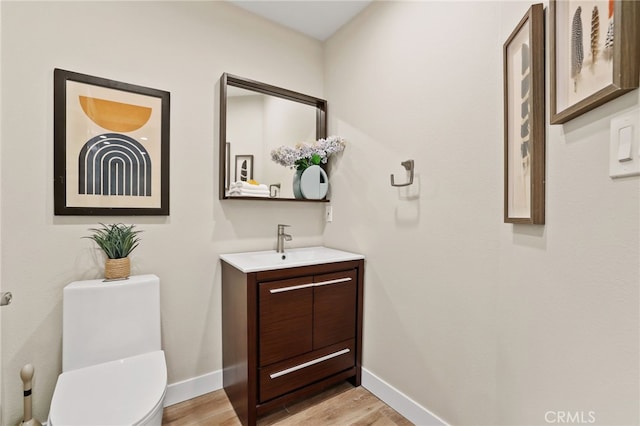 77 Seton Rd, Irvine, CA 92612 - bathroom featuring vanity, wood finished floors, baseboards, and toilet
