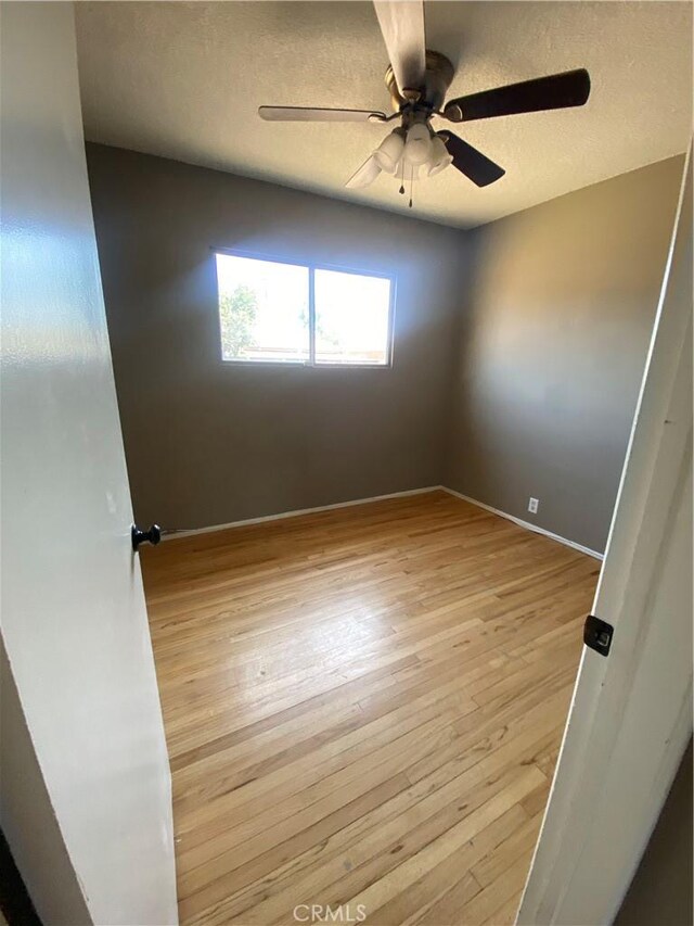 1134 E Highland Ct, Ontario, CA 91764 - unfurnished room featuring light wood-style flooring, a ceiling fan, a textured ceiling, and baseboards