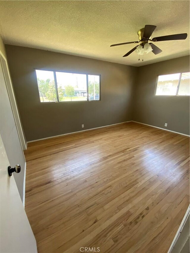 1134 E Highland Ct, Ontario, CA 91764 - spare room featuring a textured ceiling, wood finished floors, ceiling fan, and baseboards
