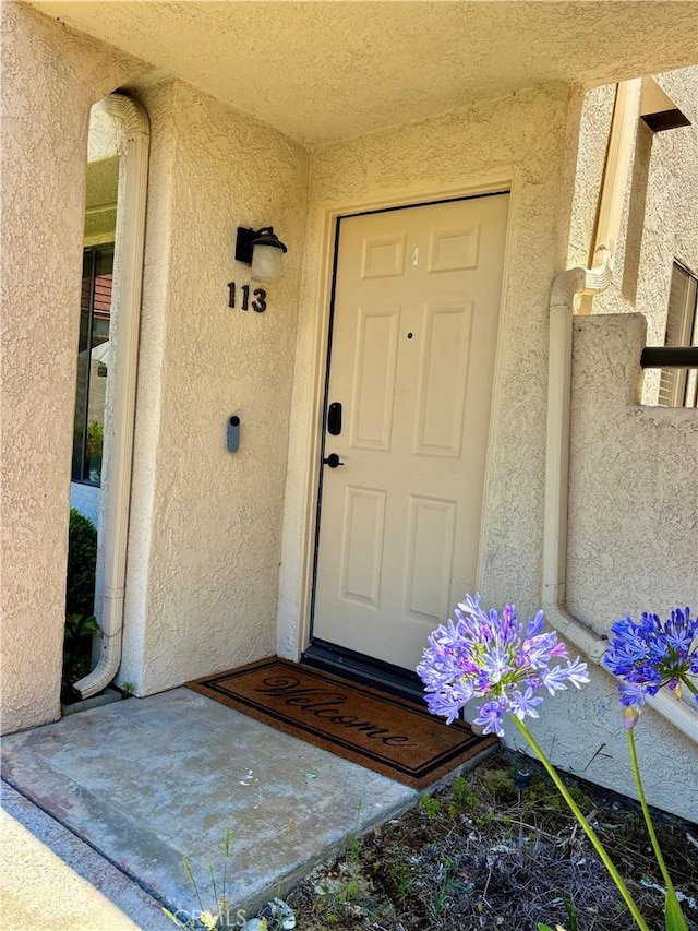 113 Pearl Unit 106, Laguna Niguel, CA 92677 - view of exterior entry with stucco siding