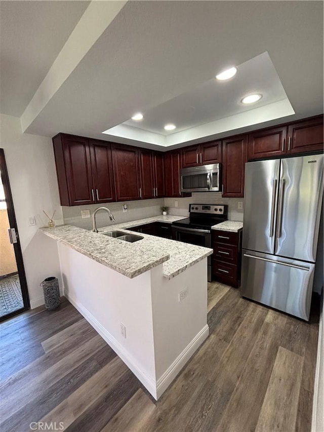 113 Pearl Unit 106, Laguna Niguel, CA 92677 - kitchen featuring stainless steel appliances, a raised ceiling, a sink, recessed lighting, and a peninsula