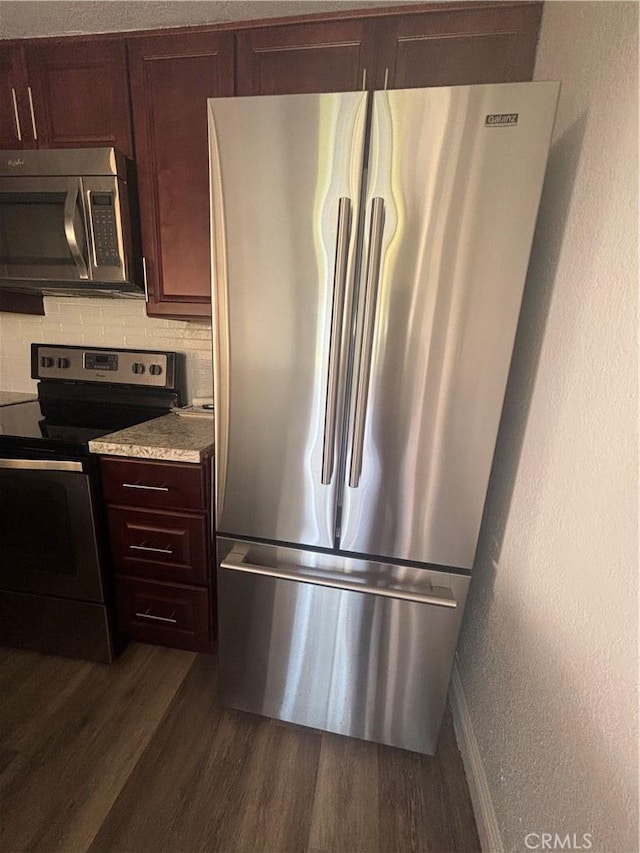 113 Pearl Unit 106, Laguna Niguel, CA 92677 - kitchen featuring stainless steel appliances, dark wood-type flooring, light countertops, baseboards, and dark brown cabinetry