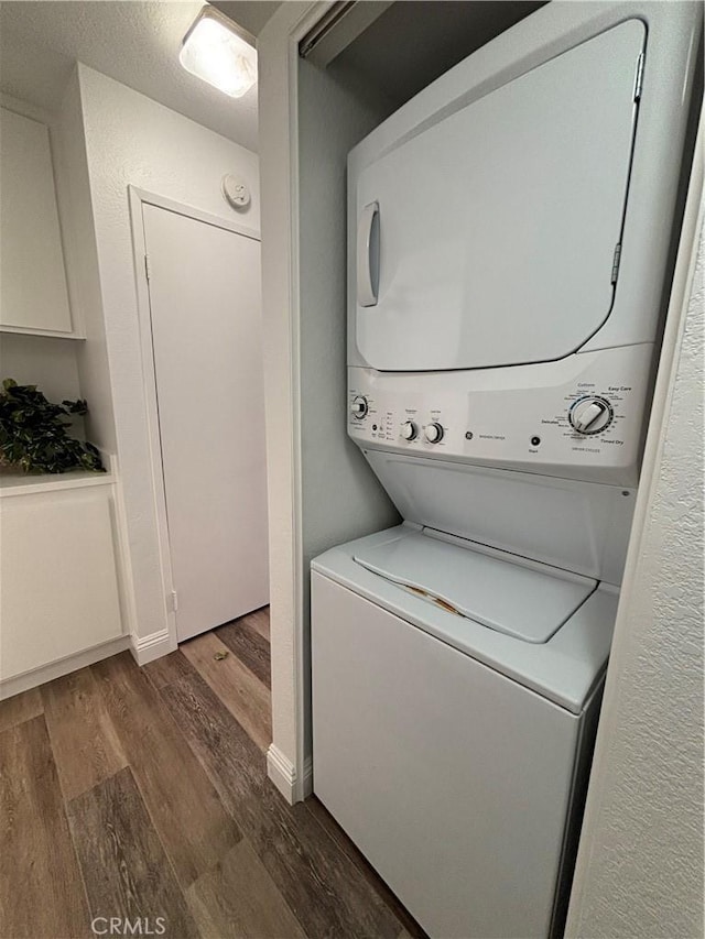 113 Pearl Unit 106, Laguna Niguel, CA 92677 - laundry area with stacked washer and clothes dryer and dark wood-type flooring