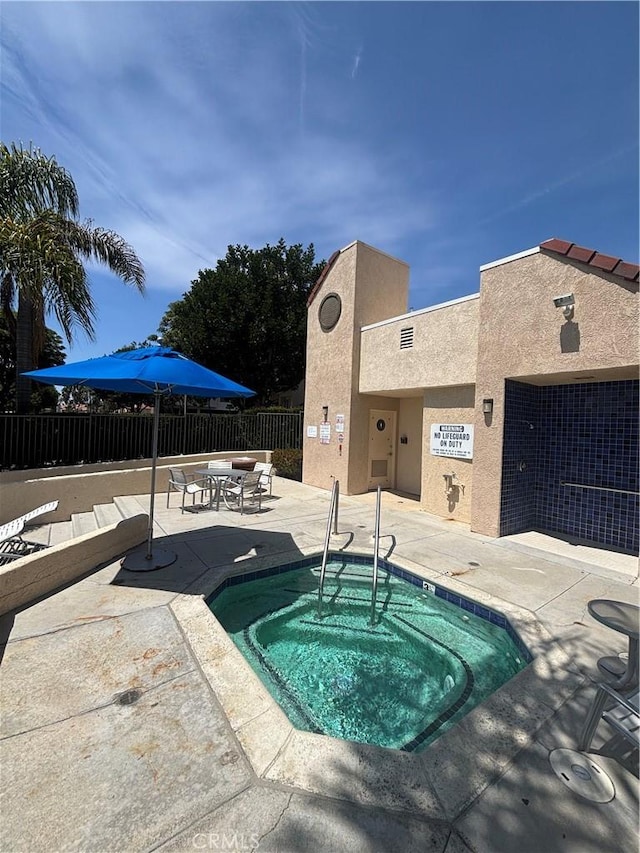 113 Pearl Unit 106, Laguna Niguel, CA 92677 - view of swimming pool with a community hot tub, a pool, and a patio