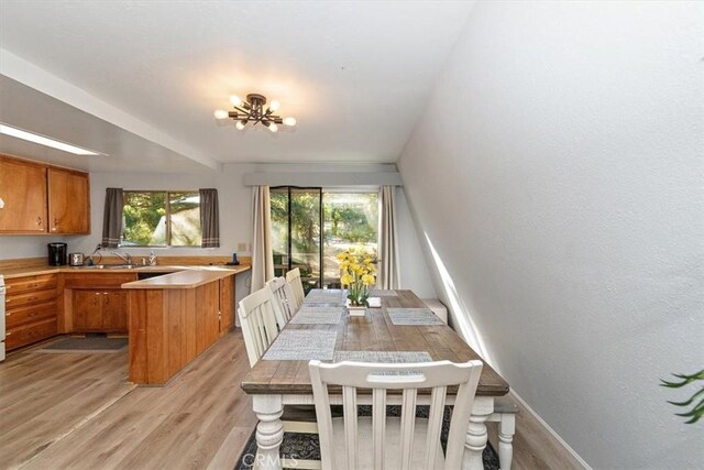 598 Dahlia Dr, Green Valley Lake, CA 92341 - dining room with light wood-style floors, a chandelier, and baseboards
