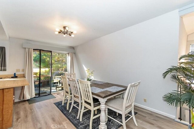 598 Dahlia Dr, Green Valley Lake, CA 92341 - dining room featuring a chandelier, light wood-type flooring, and baseboards