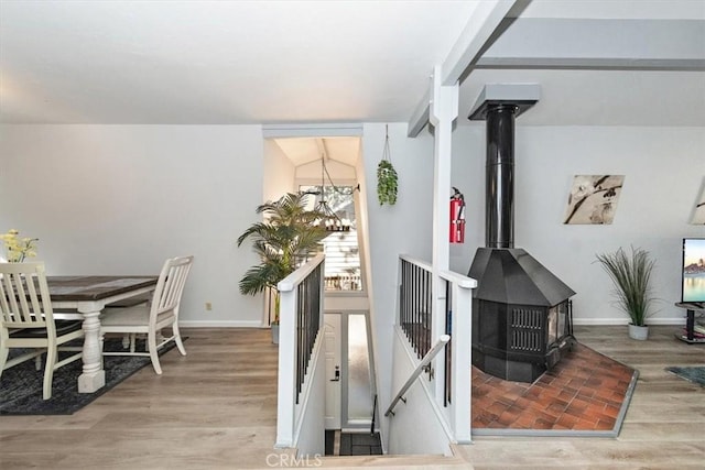 598 Dahlia Dr, Green Valley Lake, CA 92341 - dining room with a wood stove, wood finished floors, and baseboards
