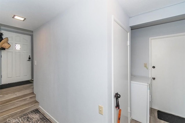 598 Dahlia Dr, Green Valley Lake, CA 92341 - doorway to outside featuring washer / dryer, stairway, and light wood-style floors