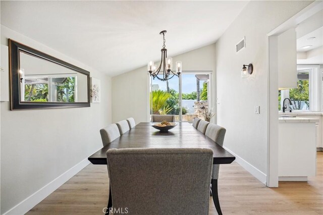 25585 Chrisanta Dr, Mission Viejo, CA 92691 - dining space with vaulted ceiling, healthy amount of natural light, a chandelier, and baseboards