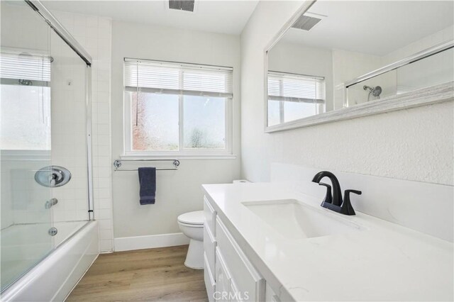 25585 Chrisanta Dr, Mission Viejo, CA 92691 - full bath featuring vanity, toilet, wood finished floors, combined bath / shower with glass door, and baseboards