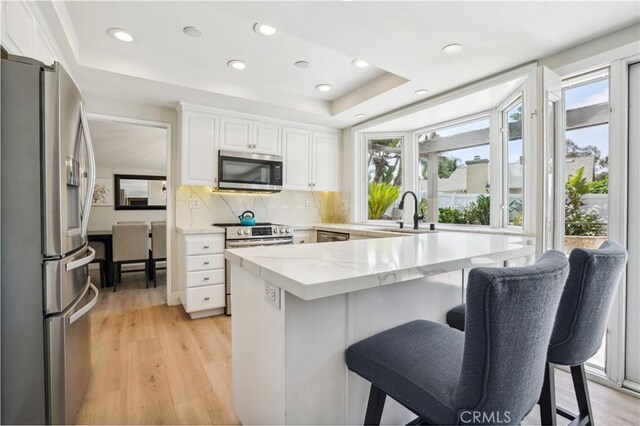 25585 Chrisanta Dr, Mission Viejo, CA 92691 - kitchen with appliances with stainless steel finishes, plenty of natural light, a sink, a breakfast bar, and recessed lighting