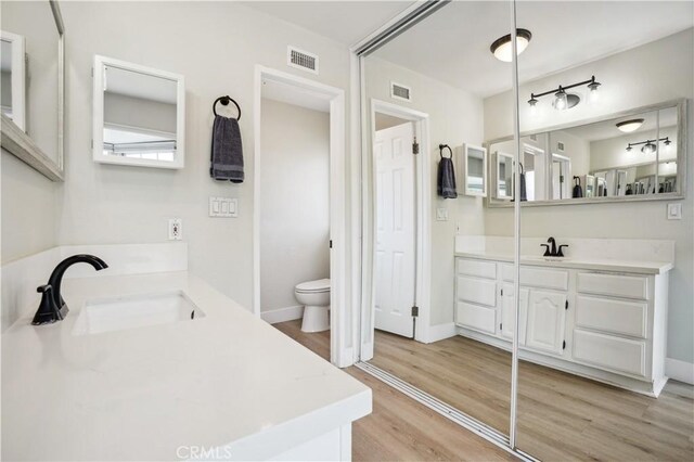 25585 Chrisanta Dr, Mission Viejo, CA 92691 - full bath with wood finished floors, toilet, two vanities, and baseboards