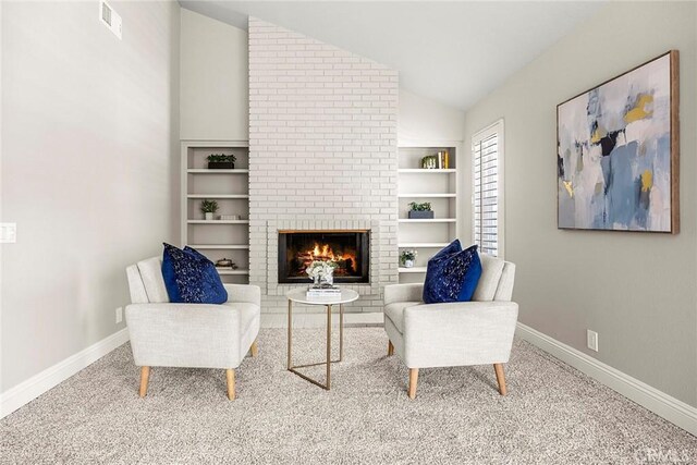 45 Colonial, Irvine, CA 92620 - living area with lofted ceiling, a fireplace, baseboards, carpet flooring, and built in shelves
