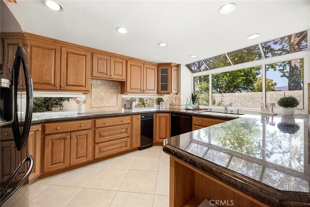 45 Colonial, Irvine, CA 92620 - kitchen featuring black appliances, brown cabinets, recessed lighting, tasteful backsplash, and light tile patterned floors