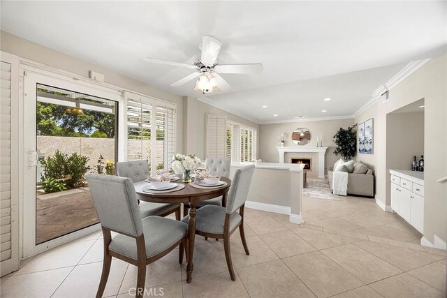 45 Colonial, Irvine, CA 92620 - dining room featuring light tile patterned floors, ceiling fan, ornamental molding, recessed lighting, and a lit fireplace