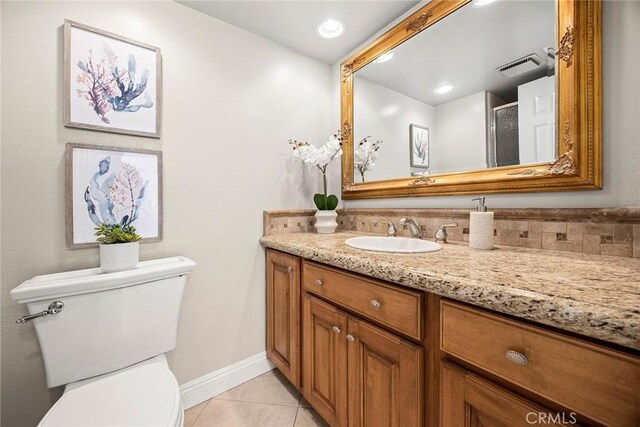 45 Colonial, Irvine, CA 92620 - full bathroom featuring tile patterned flooring, vanity, toilet, baseboards, and an enclosed shower