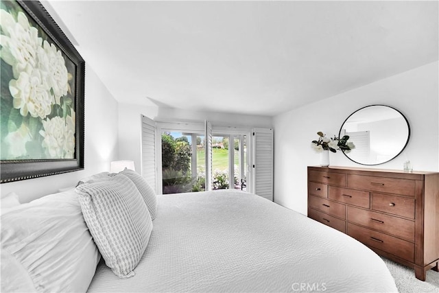 5509 Paseo Del Lago W Unit C, Laguna Woods, CA 92637 - bedroom with access to exterior and carpet flooring