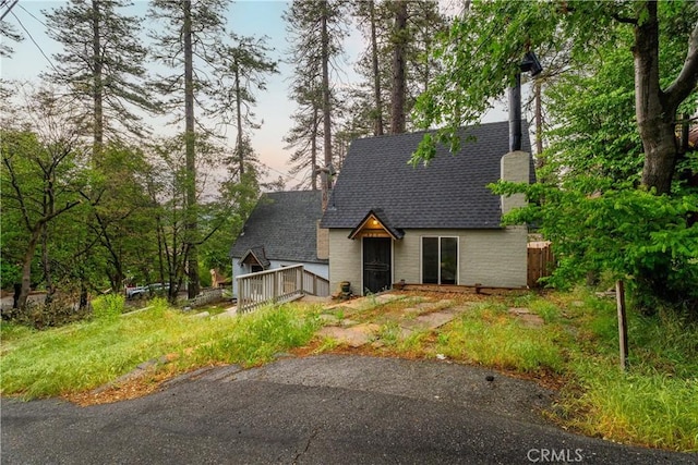 423 Forest Ln, Crestline, CA 92325 - view of front of property with a chimney, a deck, and a shingled roof