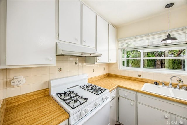 5406 Ellen Way, Banning, CA 92220 - kitchen with white gas range, under cabinet range hood, a sink, tasteful backsplash, and white cabinetry
