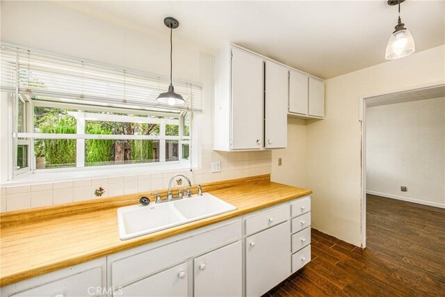 5406 Ellen Way, Banning, CA 92220 - kitchen with a sink, tasteful backsplash, dark wood finished floors, white cabinets, and light countertops