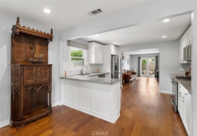 1526 Garden St, San Luis Obispo, CA 93401 - kitchen with stainless steel appliances, light stone countertops, white cabinetry, dark wood-type flooring, and recessed lighting