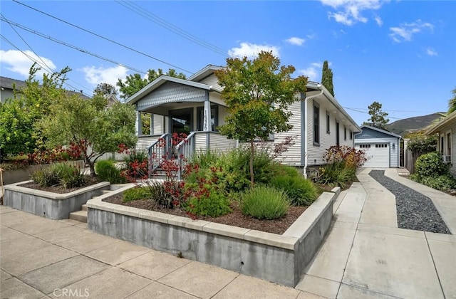 1526 Garden St, San Luis Obispo, CA 93401 - view of front of property featuring covered porch, an outbuilding, a detached garage, and concrete driveway