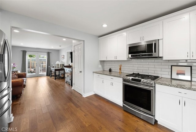 1526 Garden St, San Luis Obispo, CA 93401 - kitchen with appliances with stainless steel finishes, light stone counters, tasteful backsplash, white cabinetry, and dark wood-style floors