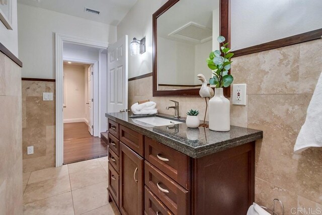 1530 Stewart St, Oceanside, CA 92054 - bathroom featuring tile walls, vanity, tile patterned floors, and wainscoting