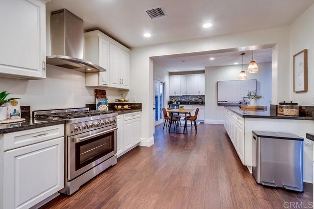 1530 Stewart St, Oceanside, CA 92054 - kitchen featuring wall chimney exhaust hood, high end range, white cabinetry, dark wood-style flooring, and recessed lighting