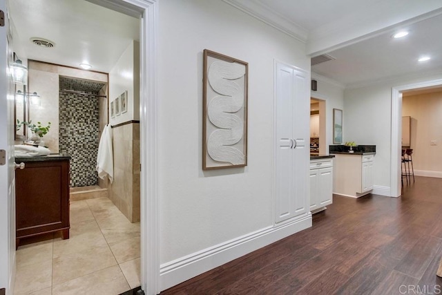 1530 Stewart St, Oceanside, CA 92054 - corridor featuring ornamental molding, wood finished floors, and recessed lighting