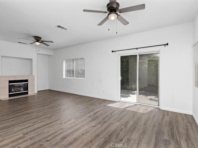 26230 Monticello Way, Murrieta, CA 92563 - unfurnished living room featuring ceiling fan, wood finished floors, a tile fireplace, and baseboards