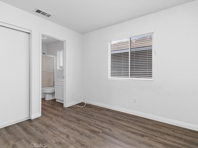 26230 Monticello Way, Murrieta, CA 92563 - unfurnished bedroom featuring dark wood finished floors, baseboards, a closet, and ensuite bath