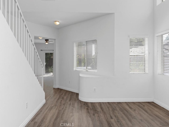 26230 Monticello Way, Murrieta, CA 92563 - unfurnished room with wood finished floors, baseboards, a ceiling fan, and stairs
