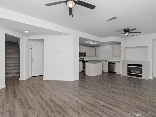 26230 Monticello Way, Murrieta, CA 92563 - unfurnished living room with ceiling fan, a sink, baseboards, and dark wood-style flooring