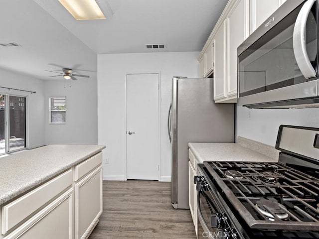 26230 Monticello Way, Murrieta, CA 92563 - kitchen featuring stainless steel appliances, light wood-type flooring, ceiling fan, white cabinets, and light countertops