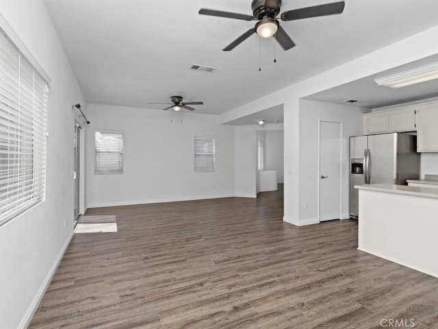 26230 Monticello Way, Murrieta, CA 92563 - unfurnished living room featuring a ceiling fan, dark wood-style flooring, and baseboards