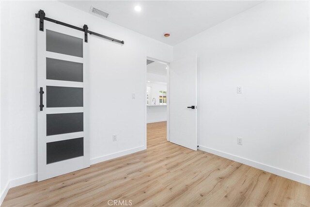 2731 Armour Ln, Redondo Beach, CA 90278 - unfurnished bedroom with wood finished floors and a barn door
