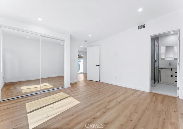 2731 Armour Ln, Redondo Beach, CA 90278 - unfurnished bedroom featuring wood finished floors, recessed lighting, a closet, and connected bathroom