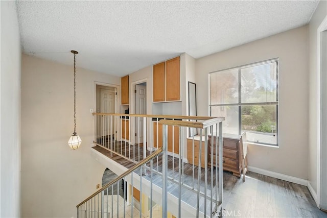 918 Sequoia Ct, San Dimas, CA 91773 - staircase with a textured ceiling, wood finished floors, and baseboards