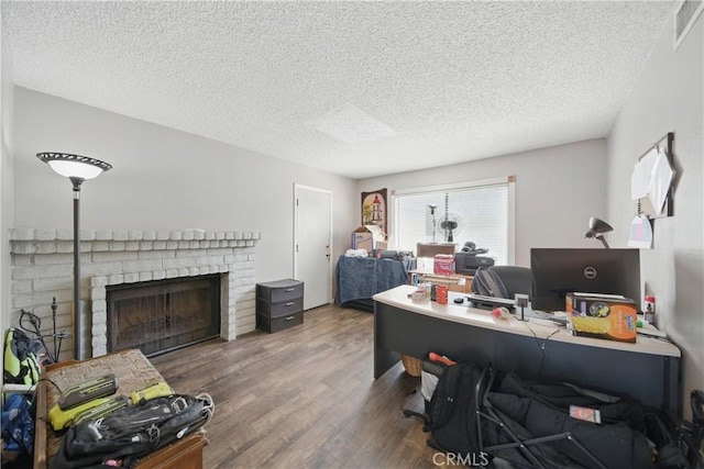 918 Sequoia Ct, San Dimas, CA 91773 - office with a textured ceiling, wood finished floors, and a brick fireplace