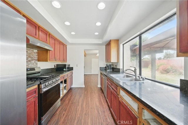 918 Sequoia Ct, San Dimas, CA 91773 - kitchen with stainless steel appliances, under cabinet range hood, dark wood-type flooring, a sink, and recessed lighting