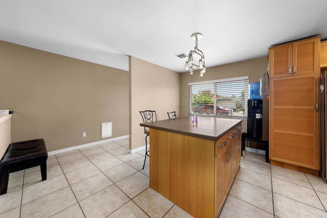 8644 Spring Vista Way, Spring Valley, CA 91977 - kitchen with a kitchen island, light tile patterned floors, a chandelier, and dark countertops