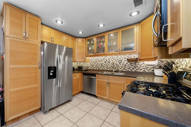 8644 Spring Vista Way, Spring Valley, CA 91977 - kitchen with stainless steel appliances, a sink, dark countertops, light tile patterned floors, and recessed lighting