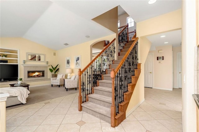 30 Sunswept Mesa, Aliso Viejo, CA 92656 - staircase featuring tile patterned flooring, a fireplace, carpet flooring, high vaulted ceiling, and built in shelves