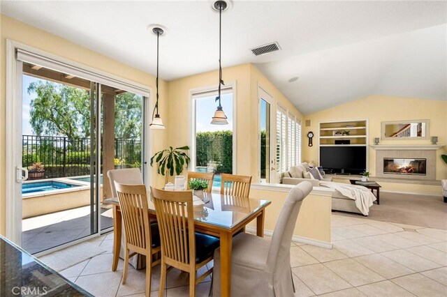 30 Sunswept Mesa, Aliso Viejo, CA 92656 - dining area featuring built in features, light tile patterned flooring, lofted ceiling, and a glass covered fireplace