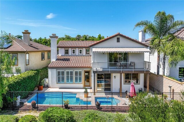 30 Sunswept Mesa, Aliso Viejo, CA 92656 - rear view of property featuring a balcony, stucco siding, a patio, a tile roof, and a pool with connected hot tub