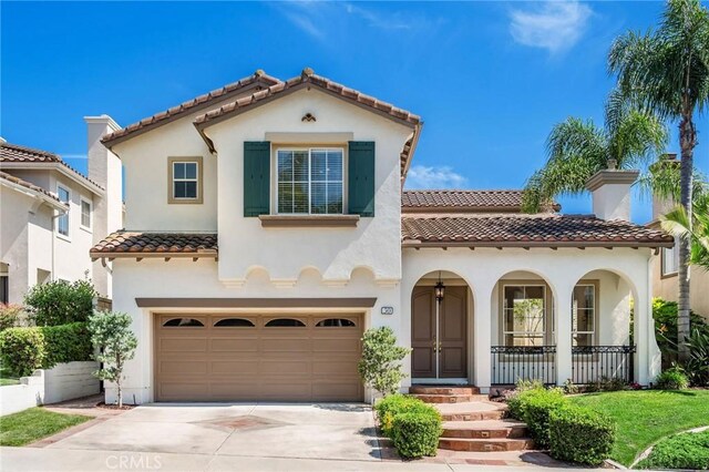 30 Sunswept Mesa, Aliso Viejo, CA 92656 - mediterranean / spanish home with a tiled roof, a garage, stucco siding, driveway, and a porch